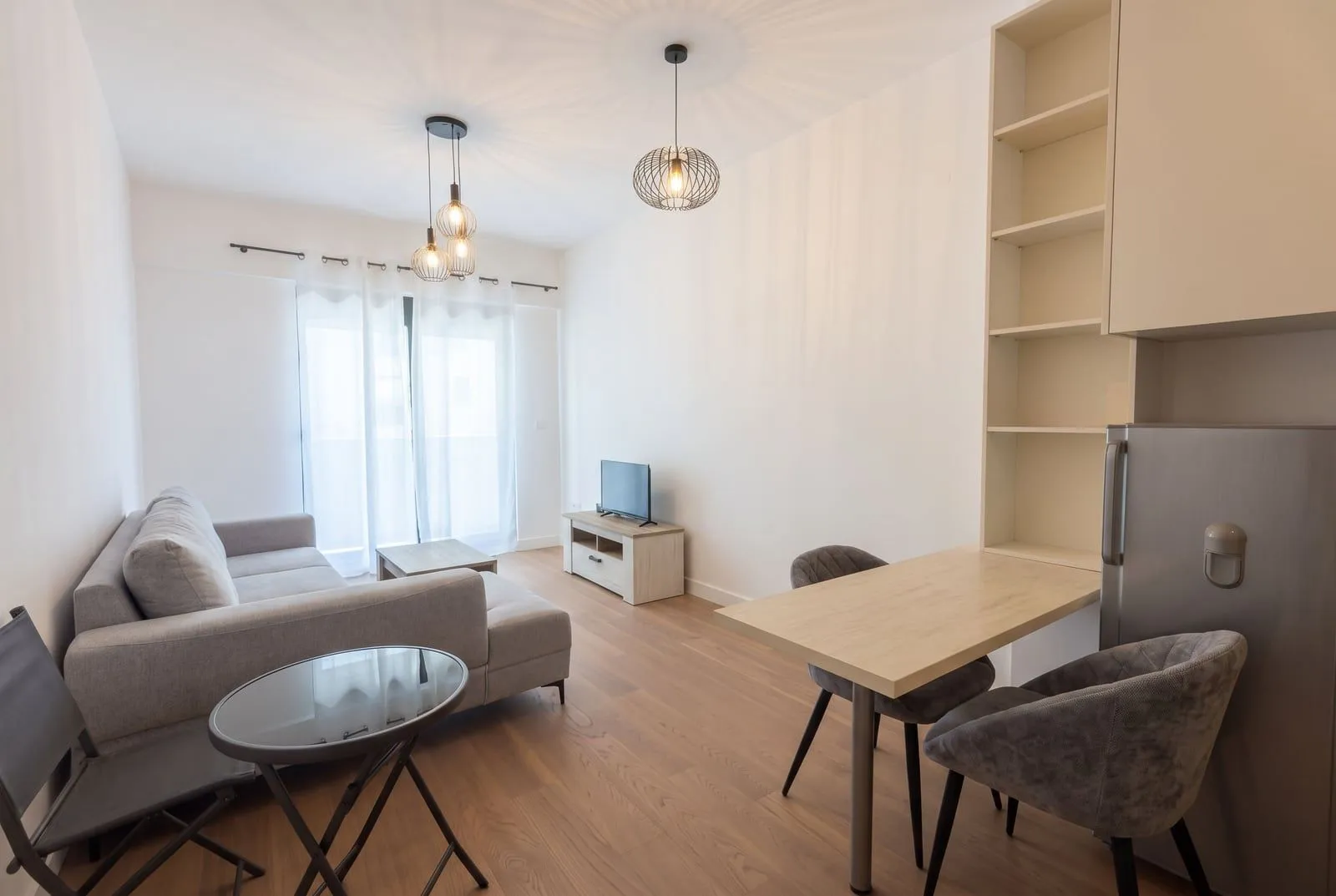 Bright living room with dining area and a sofa.