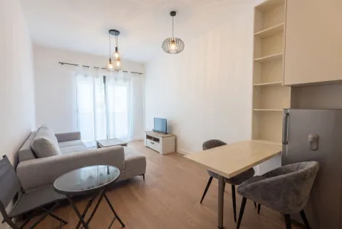 Bright living room with dining area and a sofa. - image 2