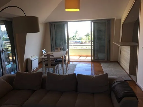 Spacious living room with a dining area and balcony access.