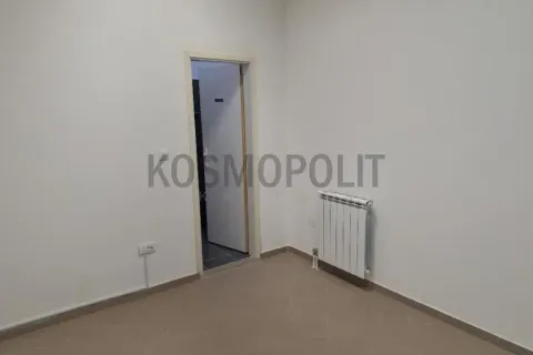 Empty room with light walls, tiled floors, and a radiator. - image 10