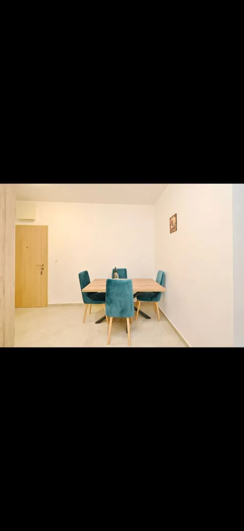 Dining area with a wooden table and blue chairs.