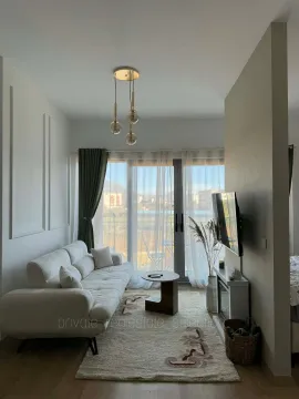 Furnished living room with a light sofa and access to the terrace. - image 2
