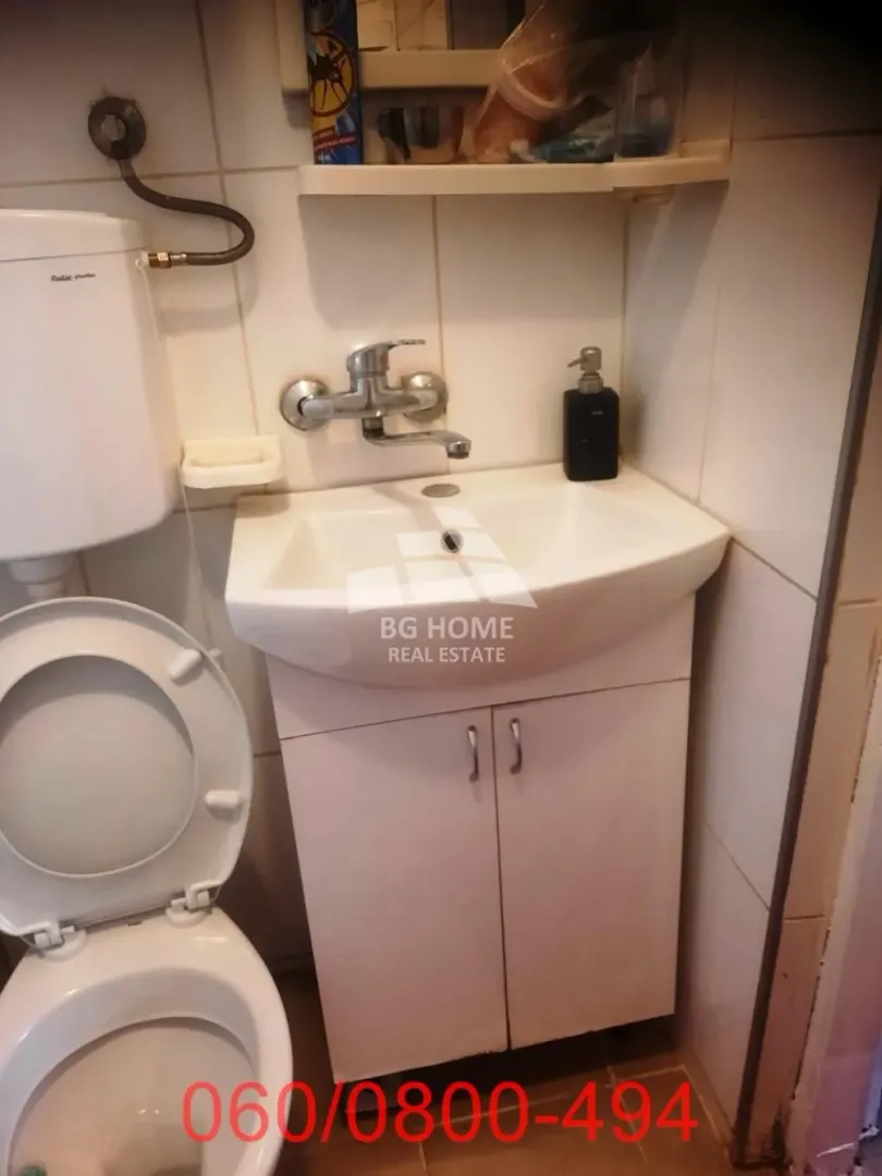 Smaller bathroom with a sink, cabinet, and toilet.