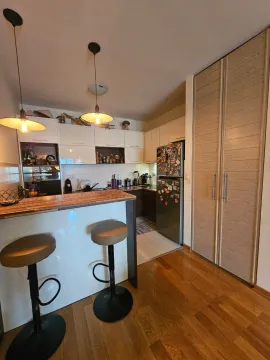 Kitchen with a bar counter and dining table. - image 4