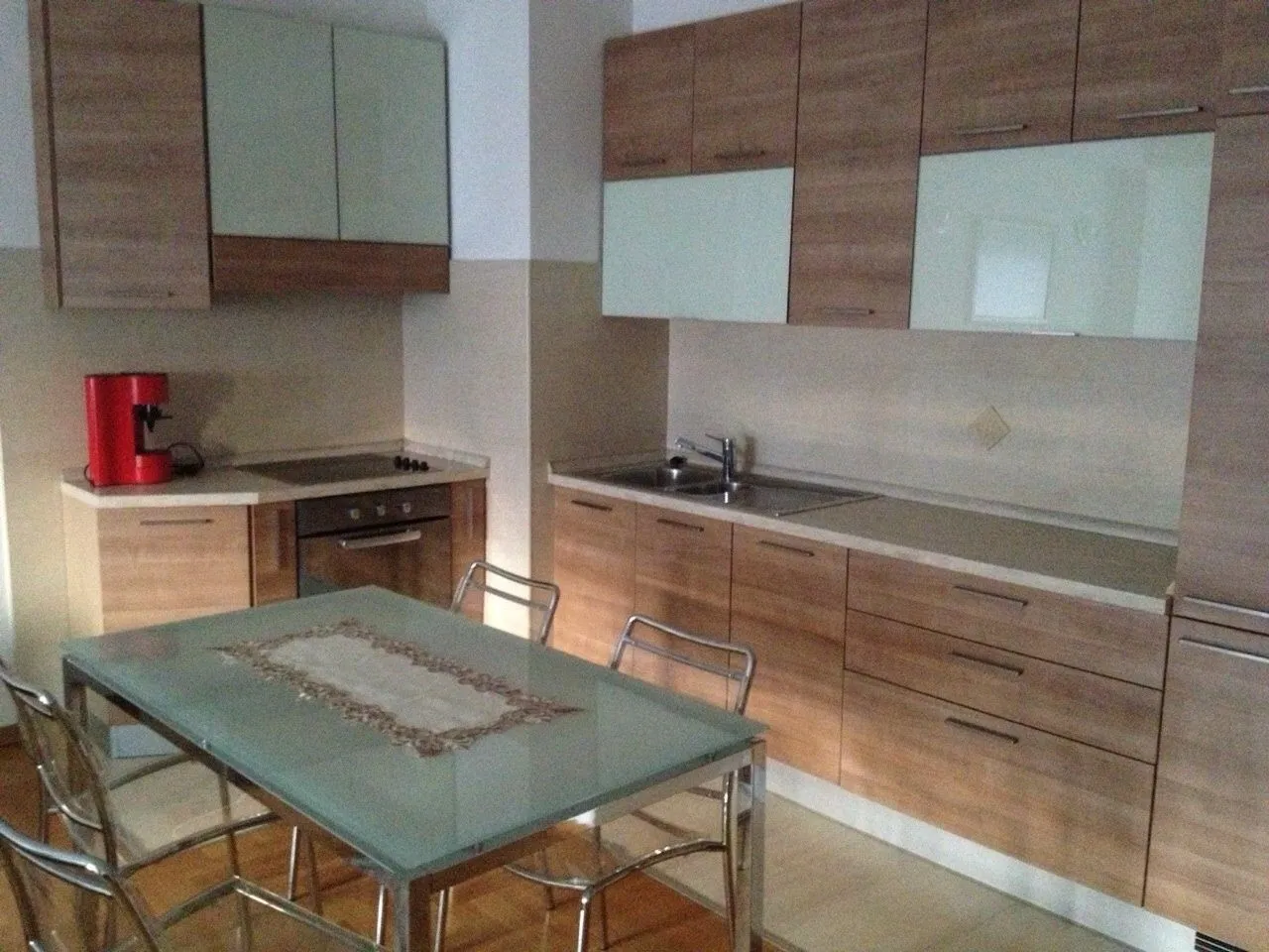 Kitchen with wooden elements and a dining table.