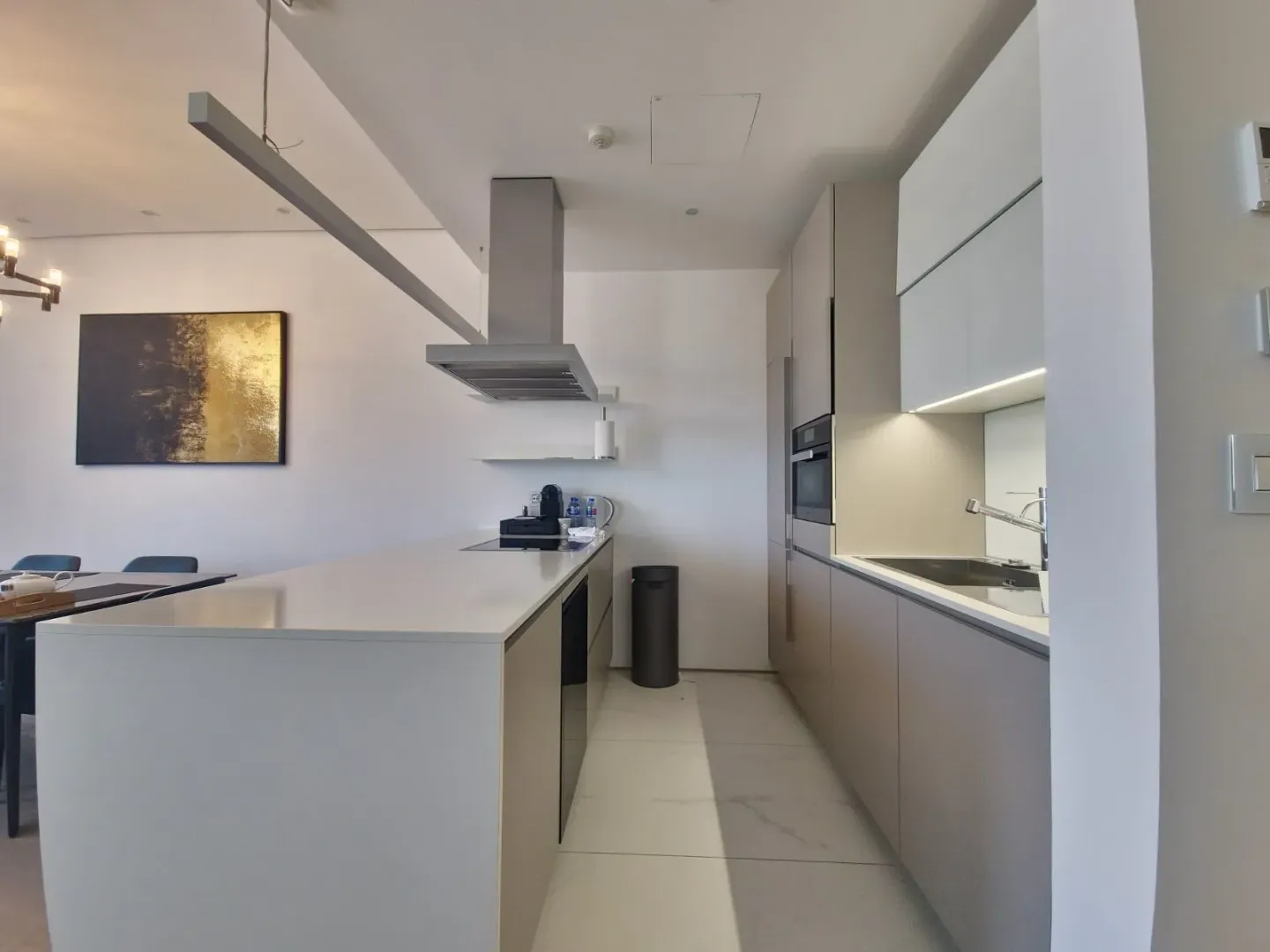Modern kitchen with an island and built-in appliances.