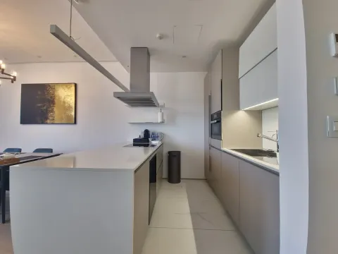Modern kitchen with an island and built-in appliances. - image 22
