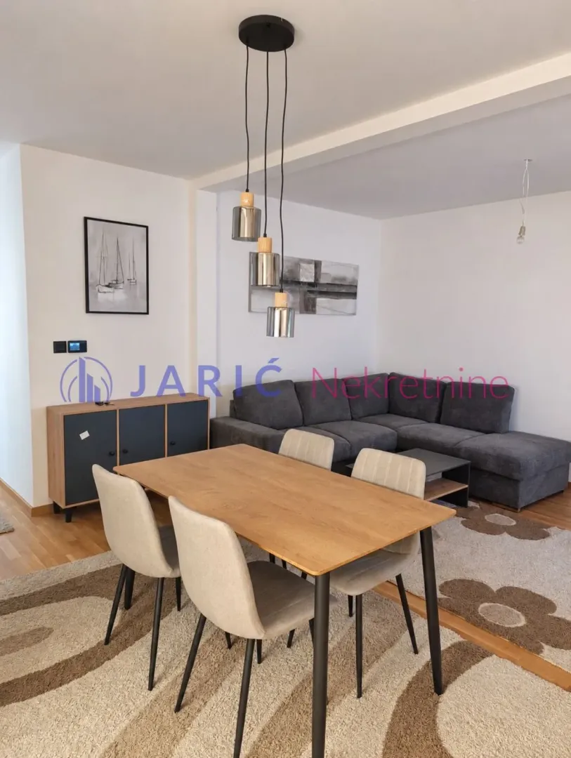 Living room with dining area and a corner sofa.