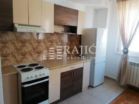Small equipped kitchen with stove and refrigerator. - image 4