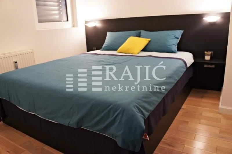 Furnished bedroom with a double bed.