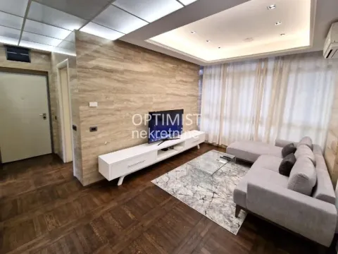 Living room with sofa, TV and parquet flooring. - image 2