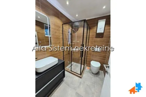 Modernly equipped bathroom with a shower cabin and a washbasin. - image 19