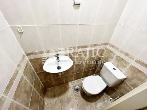 Smaller bathroom with a sink and toilet tiled with ceramic tiles. - image 16