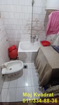 Starije opremljeno kupatilo sa kadom, bideom i pločicama na zidovima. - image 6