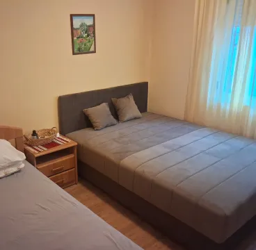 Bedroom with a double bed, nightstand, and a painting on the wall. - image 9