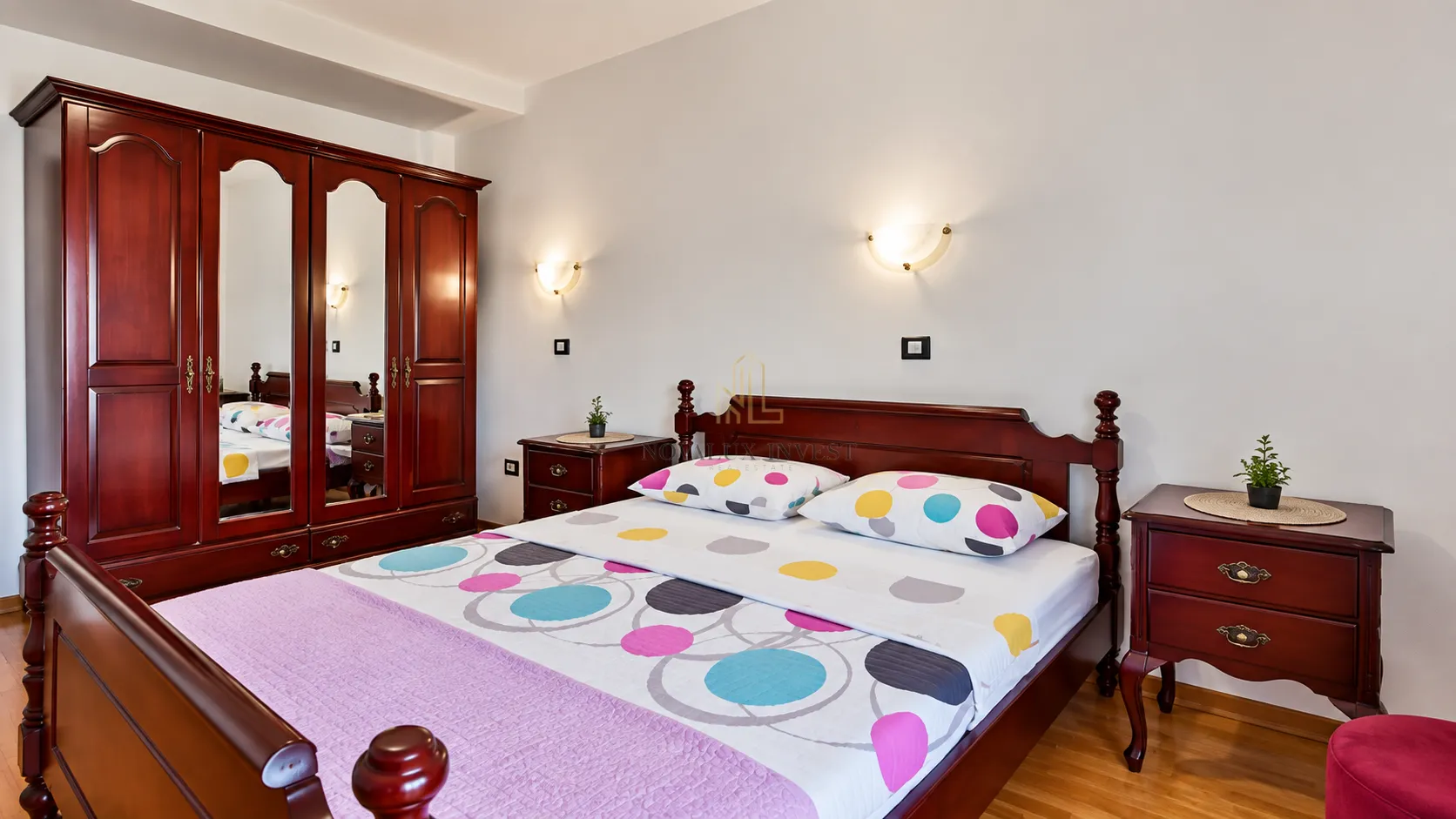 Furnished bedroom with a double bed, wardrobe, and nightstands.