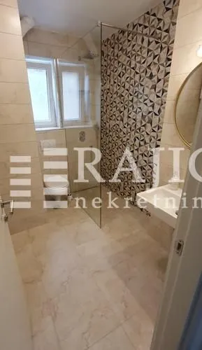 A modern bathroom equipped with a walk-in shower.