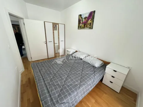 Furnished bedroom with a double bed, wardrobe, and nightstands. - image 6