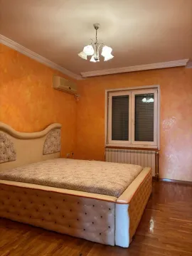 Bedroom with a double bed and orange walls. - image 16