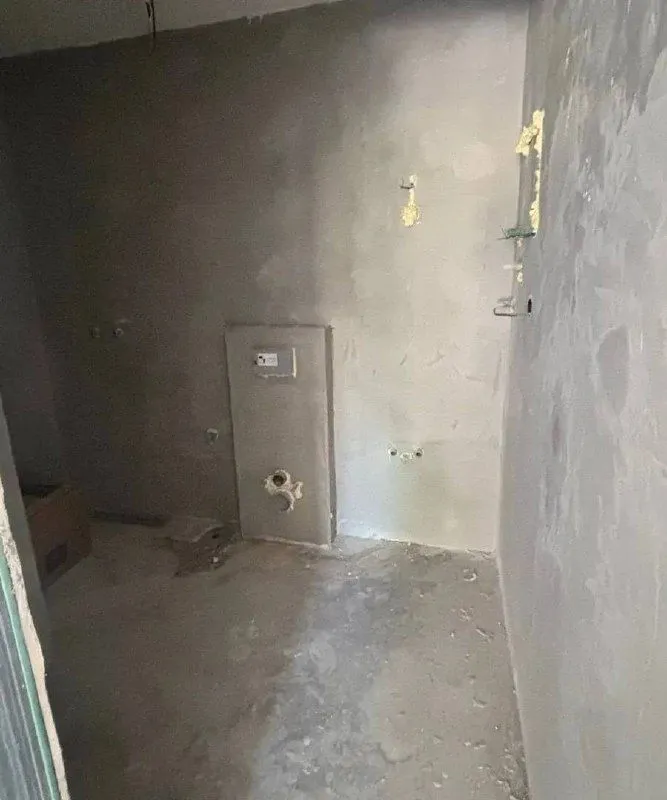 Room under construction with rough wall finishes.