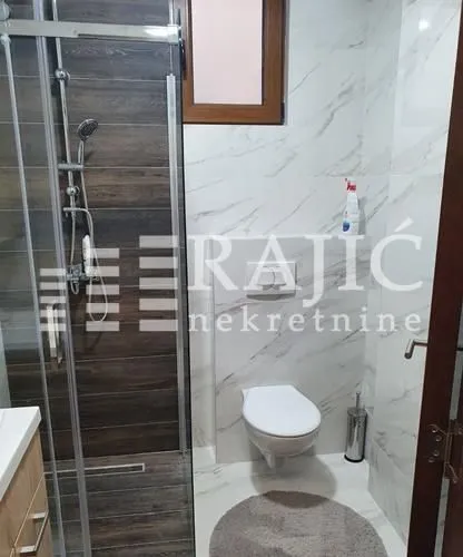 Modern equipped bathroom with a shower cabin.