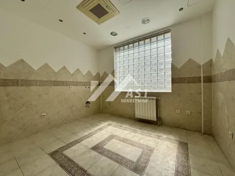 Empty room tiled with ceramic tiles and featuring a glass block window. - image 7