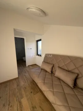 Living room with a sofa and a view towards the bathroom. - image 15