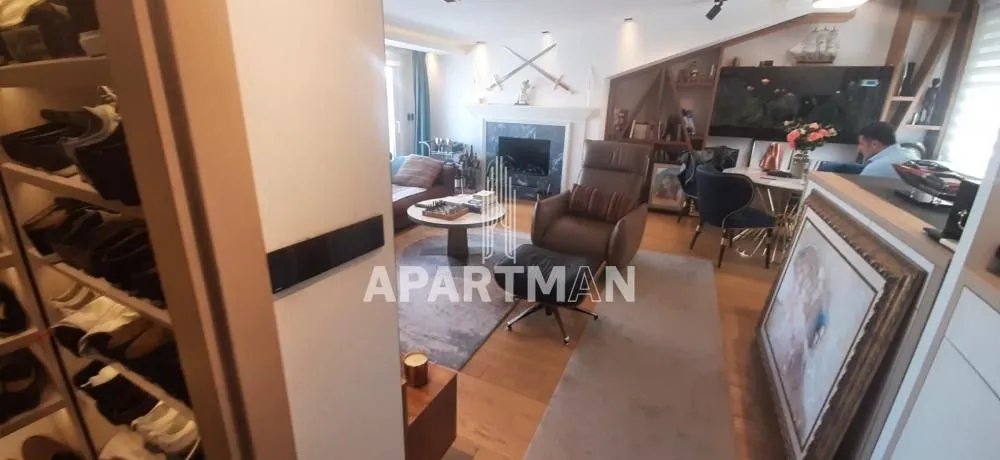 View from the hallway into the furnished living room with a fireplace and seating area.