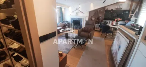 View from the hallway into the furnished living room with a fireplace and seating area. - image 12