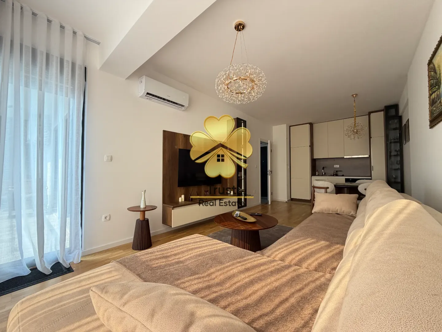 Living room with sofa and dining area in the background.