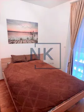 Bedroom with a double bed and a window with curtains. - image 2