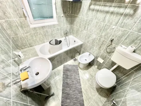 Bathroom equipped with a bathtub, washbasin, toilet, and bidet. - image 8