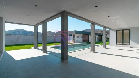 Covered terrace with a view of the swimming pool and yard. - image 10