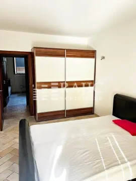 Bedroom with a bed and a large wardrobe. - image 16