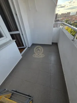 Empty and tiled balcony with a metal railing and a view of the surroundings. - image 10