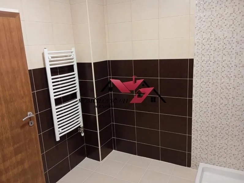 Tiled bathroom with a towel radiator.