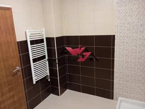 Tiled bathroom with a towel radiator. - image 10