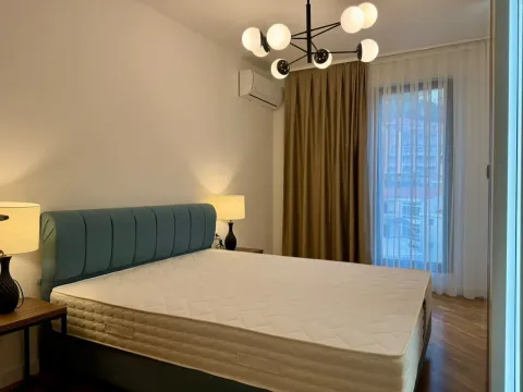 Modern bedroom with a double bed, nightstands, and a chandelier. - image 5