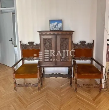 Living room with antique wooden furniture and parquet flooring. - image 7
