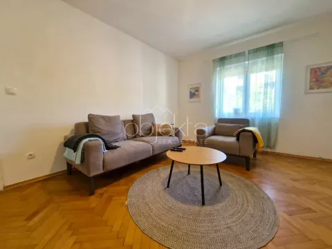 Living room with a sofa set, coffee table, and parquet flooring. - image 5