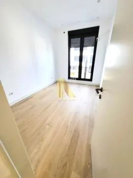 Empty bright room with parquet flooring and a large window. - image 8
