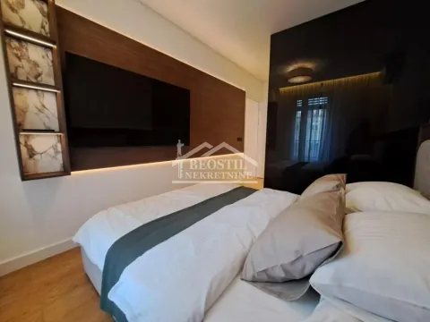 Modern bedroom with a double bed and a wall-mounted TV panel. - image 10
