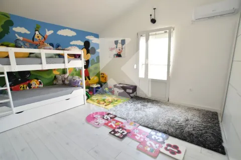 Children's bedroom with a bunk bed and cartoon-themed wallpaper. - image 17