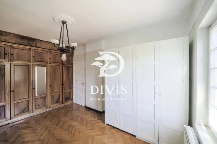 Spacious room with fitted wardrobes and parquet flooring.