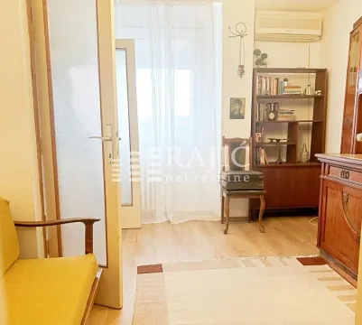 Living room with wooden furniture and access to the terrace. - image 2