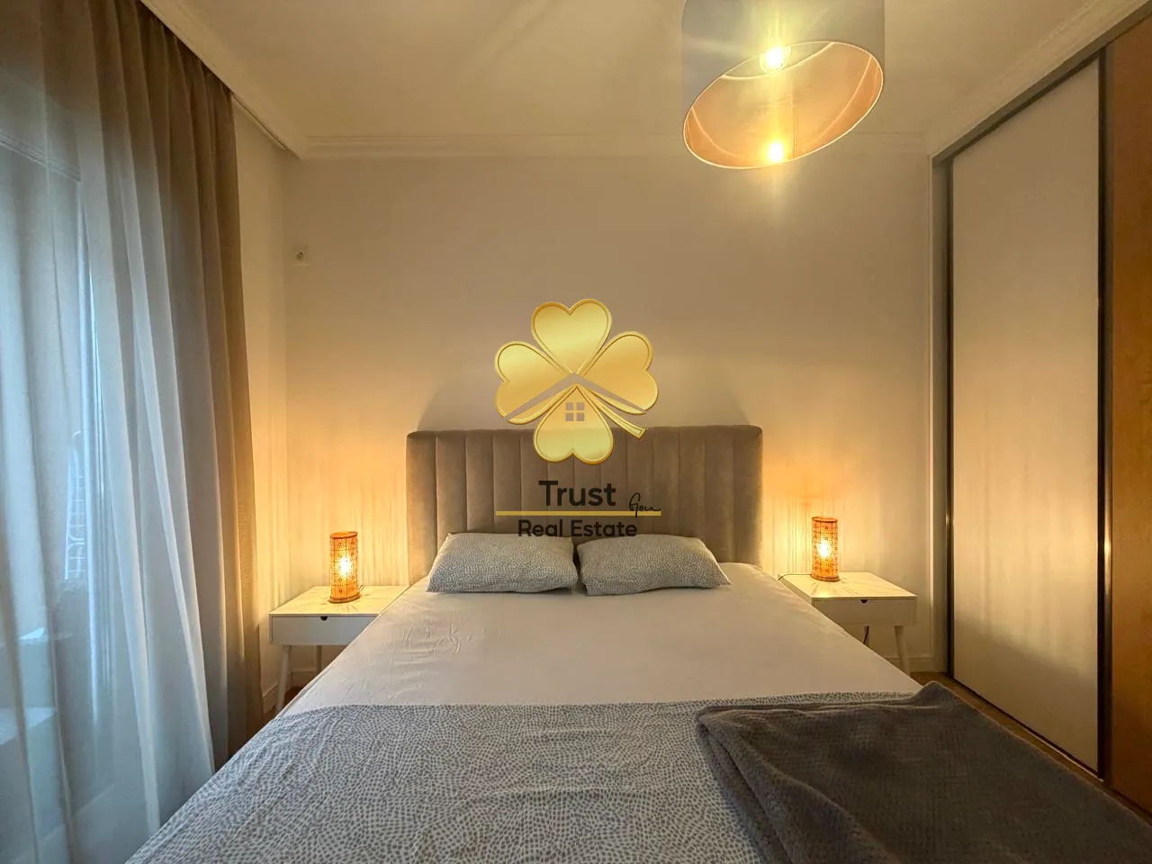 Furnished bedroom with a double bed and nightstands.