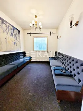 Living room with upholstered benches and a large artwork on the wall. - image 14