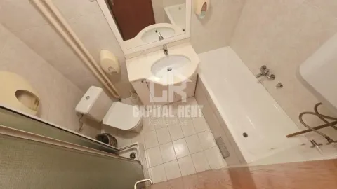 High-angle view of a bathroom equipped with a bathtub, washbasin, and toilet. - image 10