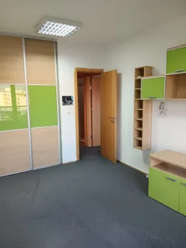 Furnished bedroom with green accents, a wardrobe, and an open door. - image 6
