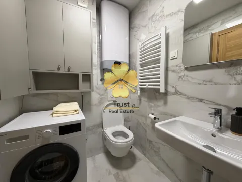 Modernly equipped bathroom with washing machine. - image 9